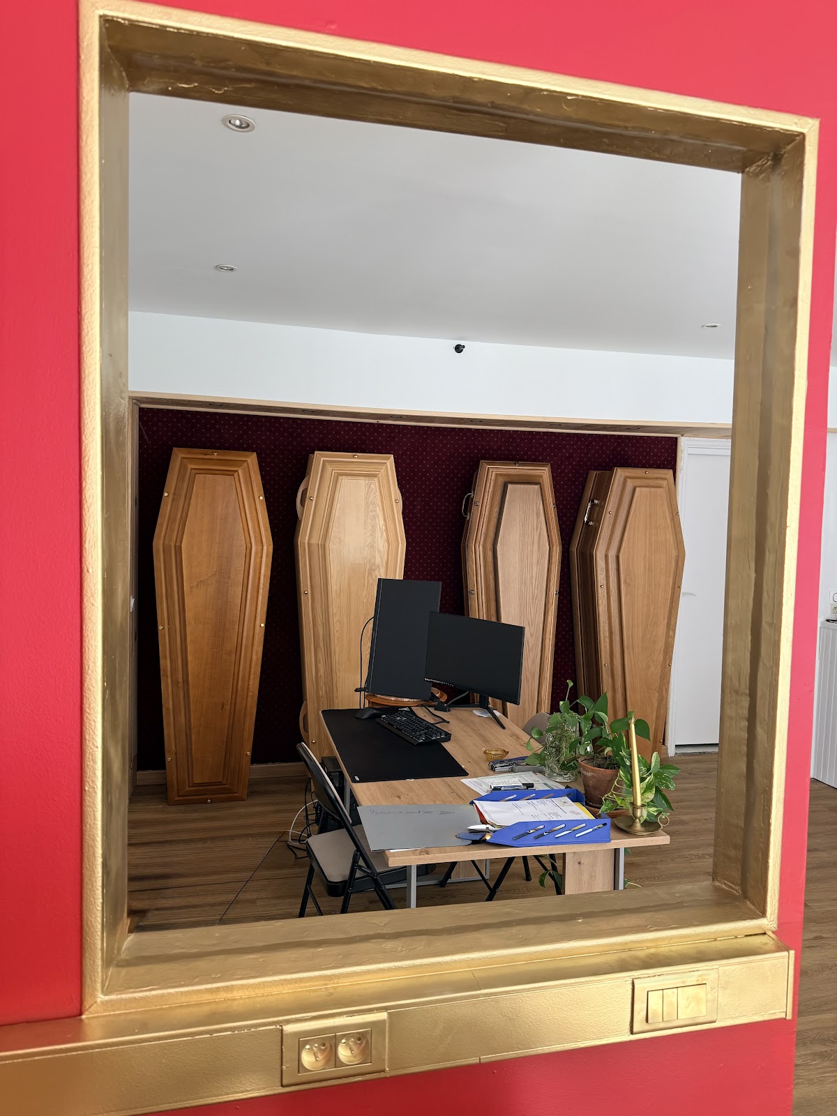 Vue intérieure du showroom à travers une baie vitrée dorée